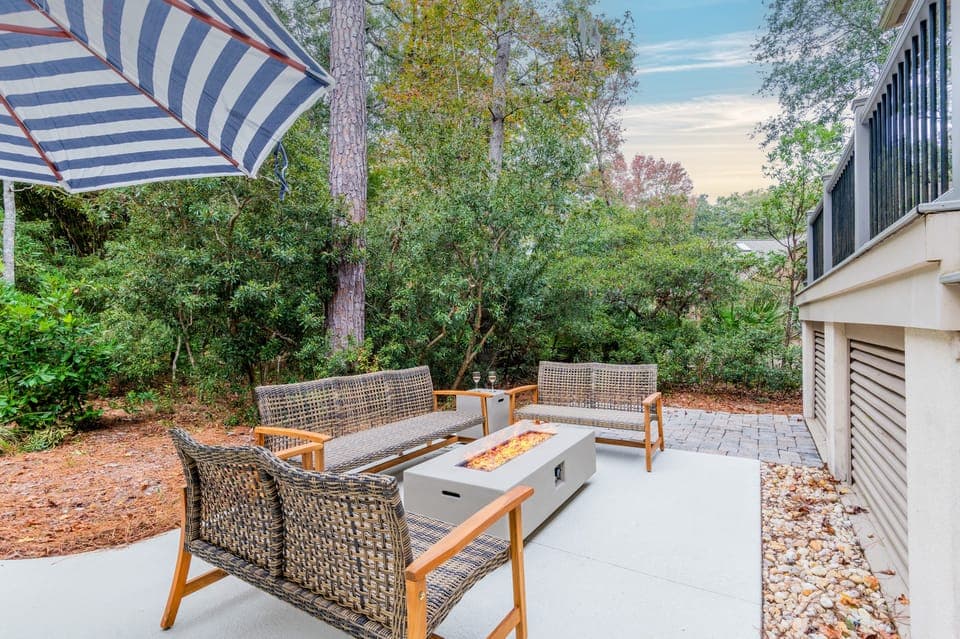 Backyard oasis features a firepit and pool.