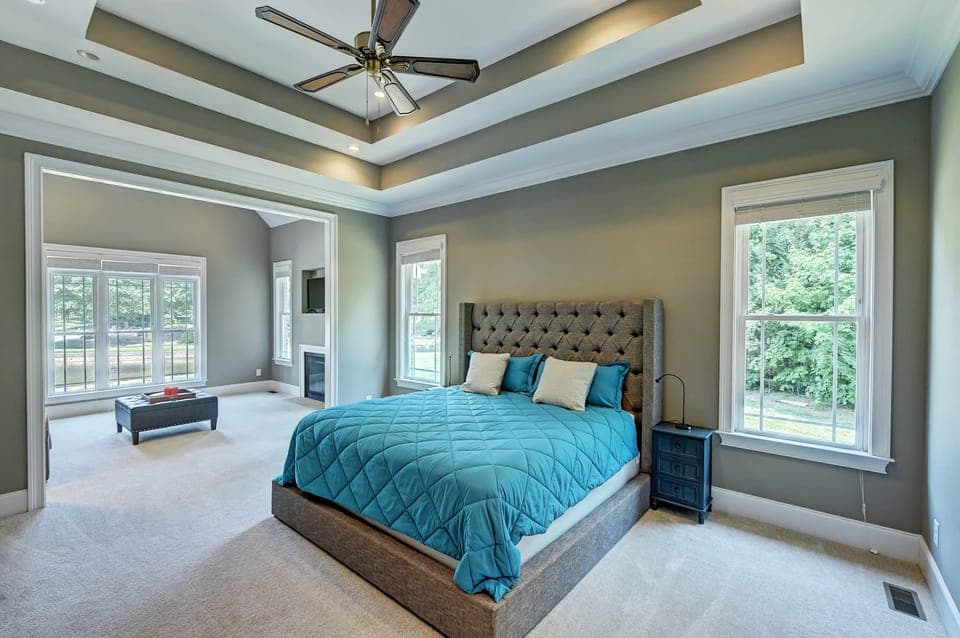 Primary bedroom features a king bed, and a sitting area with a full-size sleep sofa and fireplace.