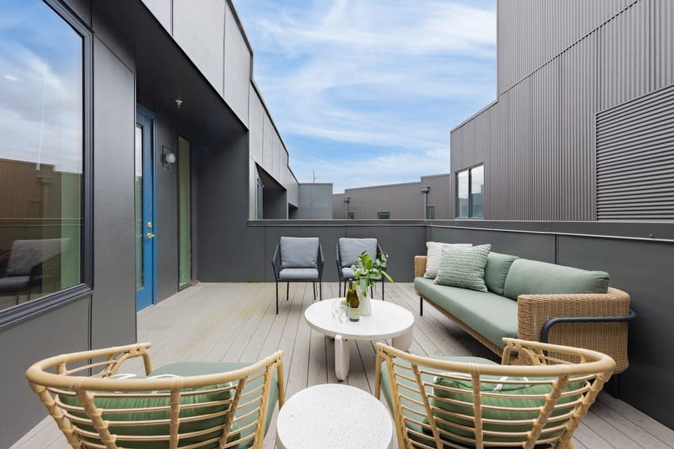 Private rooftop patio features comfortable seating.