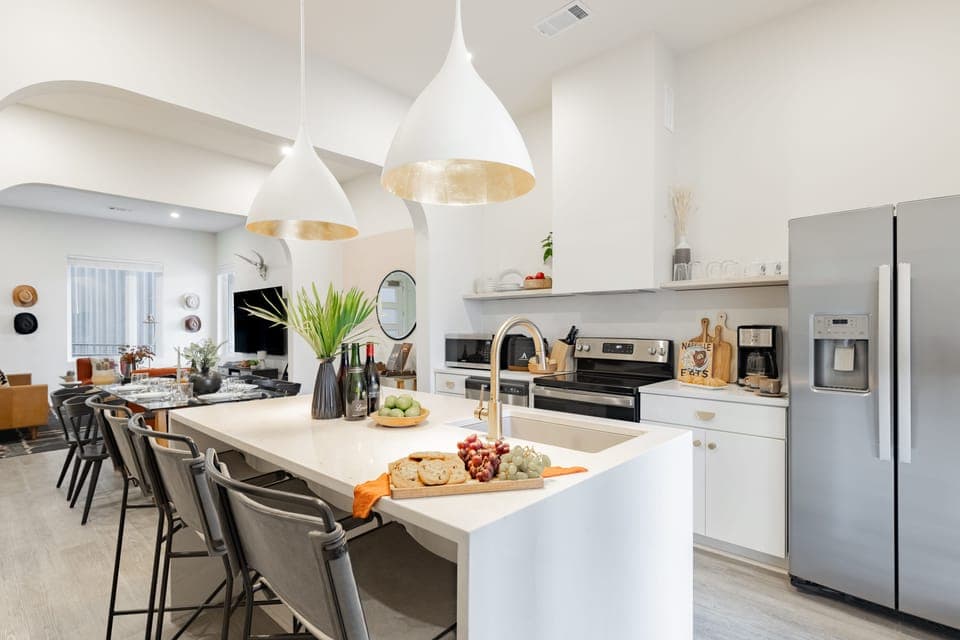 Modern, fully equipped kitchen features an island and stainless steel appliances.
