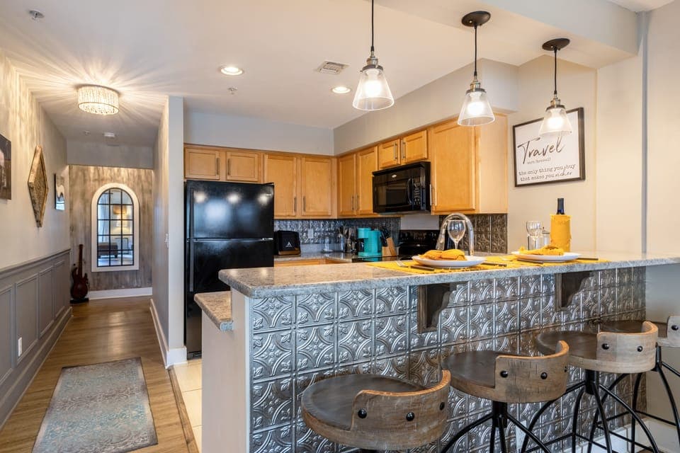 Fully equipped kitchen with barstool seating.