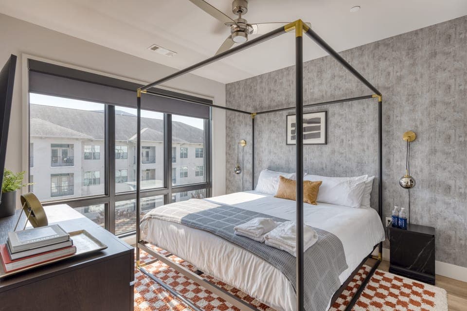 The primary bedroom features a king bed, TV, and an ensuite bathroom. (Muse)