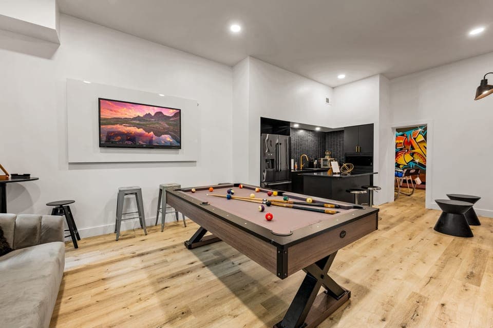 Shared lounge area with a kitchenette, bistro seating, and a pool table.
