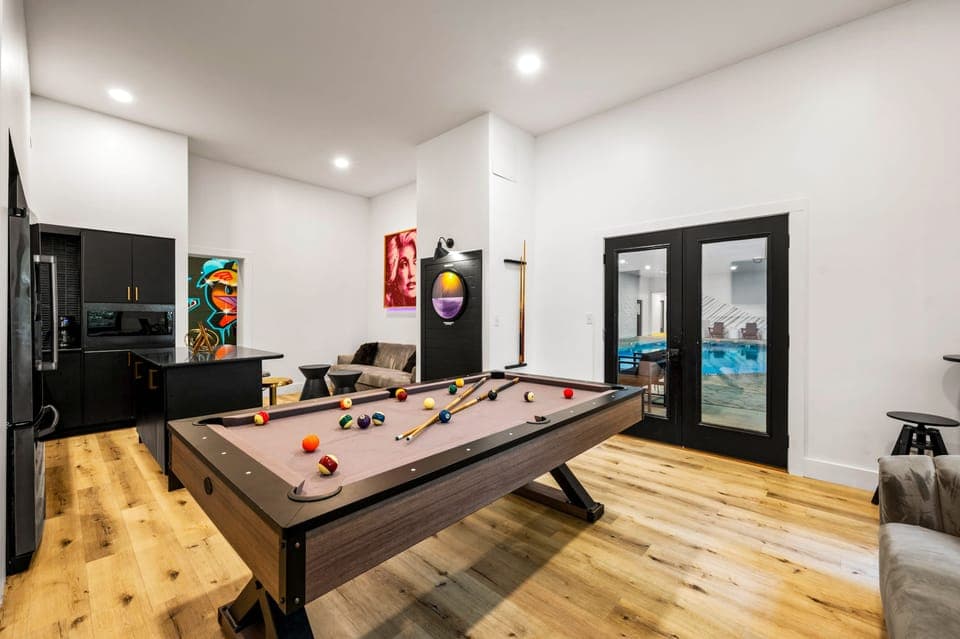 Shared lounge area with a kitchenette, bistro seating, and a pool table.