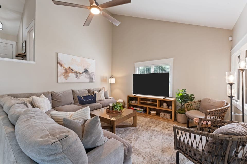 Cozy living room with plush sofa, TV, and a selection of board games for family fun.