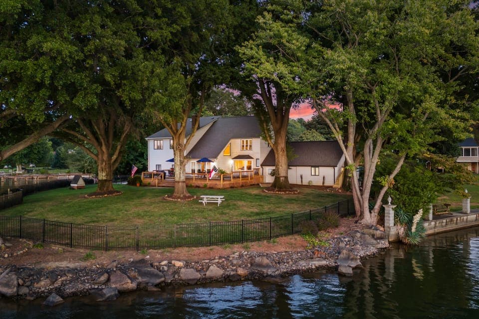 Sunset paints the sky over this stunning lakeside retreat.