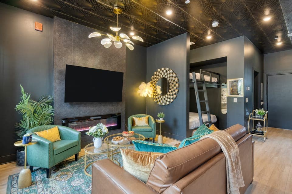 Modern living room with flat-screen TV and electric fireplace.