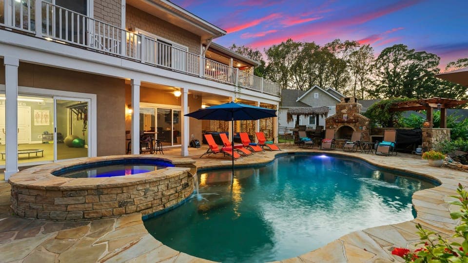 Backyard pool area with lounge seating and covered patio.