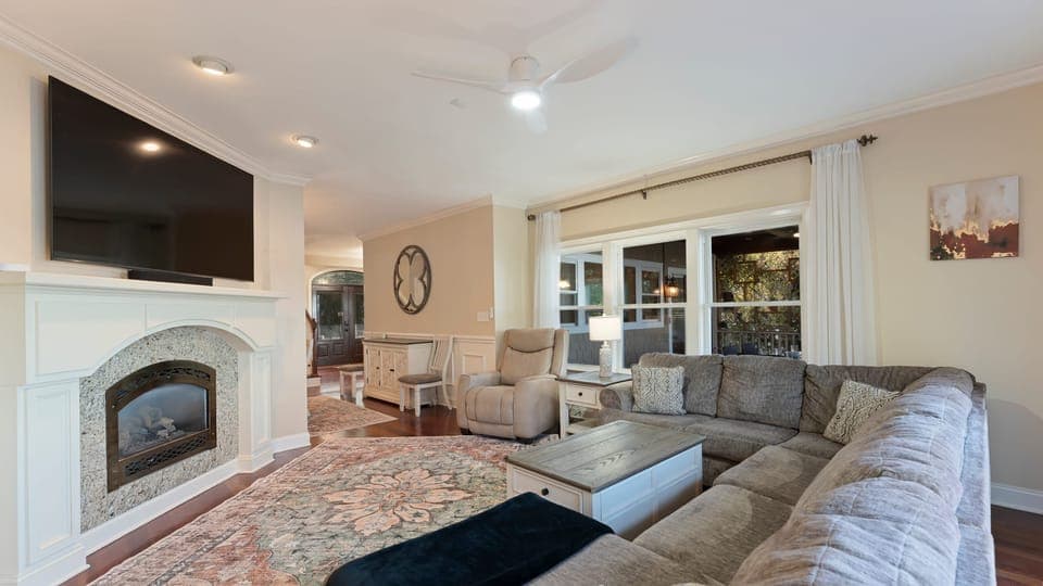 Spacious living room with sectional sofa and fireplace.