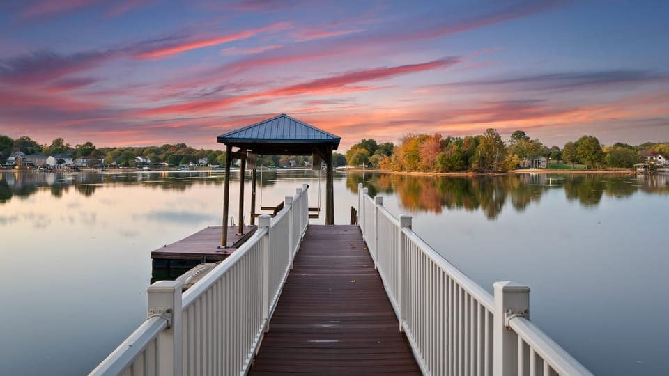 Long dock extending over calm lake water with a covered boat slip.