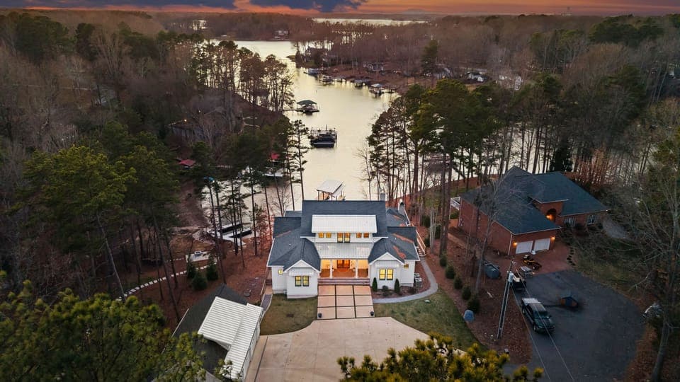 Aerial view looking down the cove with the house in the foreground at sunset.
