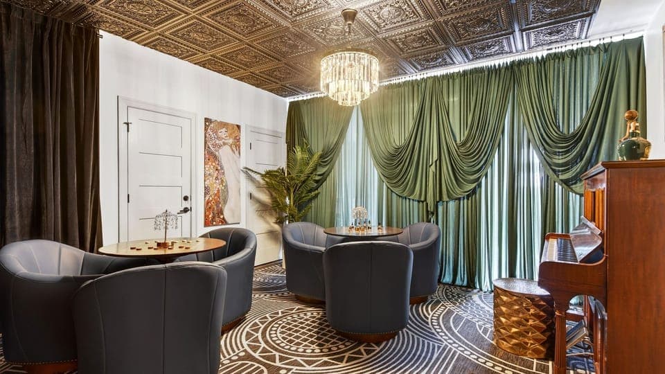 Stylish lounge with custom bar, plush seating, and statement chandelier. (The Great Gatsby)