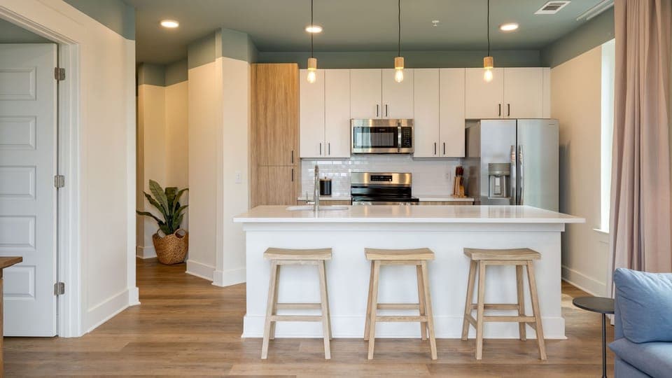 Living room with a sleep sofa and a fully equipped kitchen.