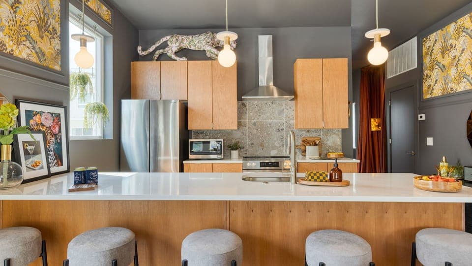 Unit 101: Sleek, modern kitchen with barstool seating.