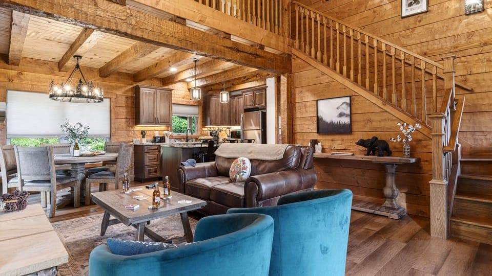 Open-concept design featuring soaring ceilings and warm wood finishes.
