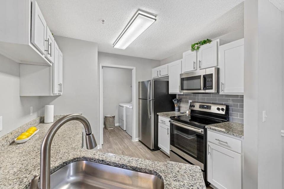Kitchen or kitchenette, dishwasher, oven, stove