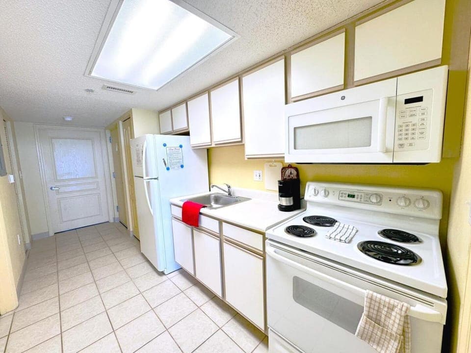 Kitchen or kitchenette, dishwasher, oven, stove