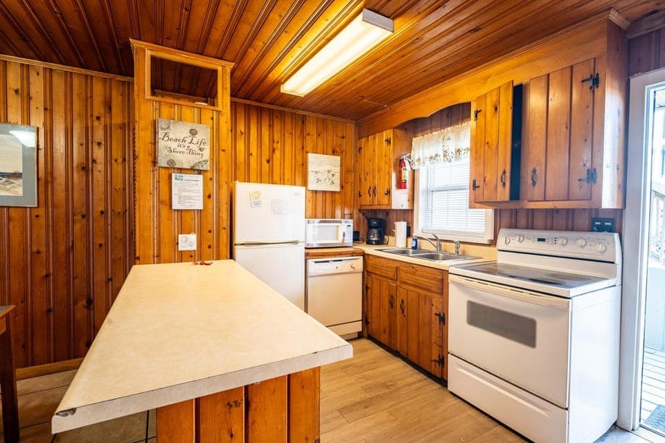 Kitchen or kitchenette, dishwasher, oven, stove