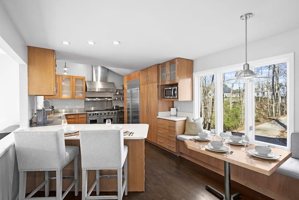 Fully stocked gourmet kitchen with bar seating for 2 and dining table with seats for 4.