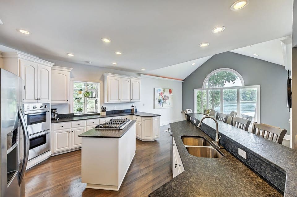 Expansive eat-in kitchen with ample bar seating, ideal for casual dining and entertaining