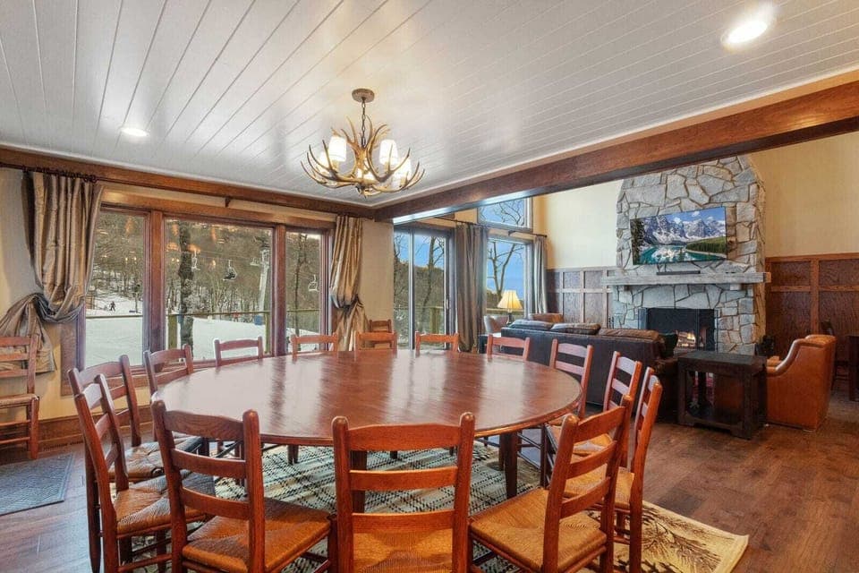 Seats 22 for Dining. Dining Table Seats 14, Plus 4 Top Table and 4 Seats at the Island. Looks out to Mountains/Ski Slopes