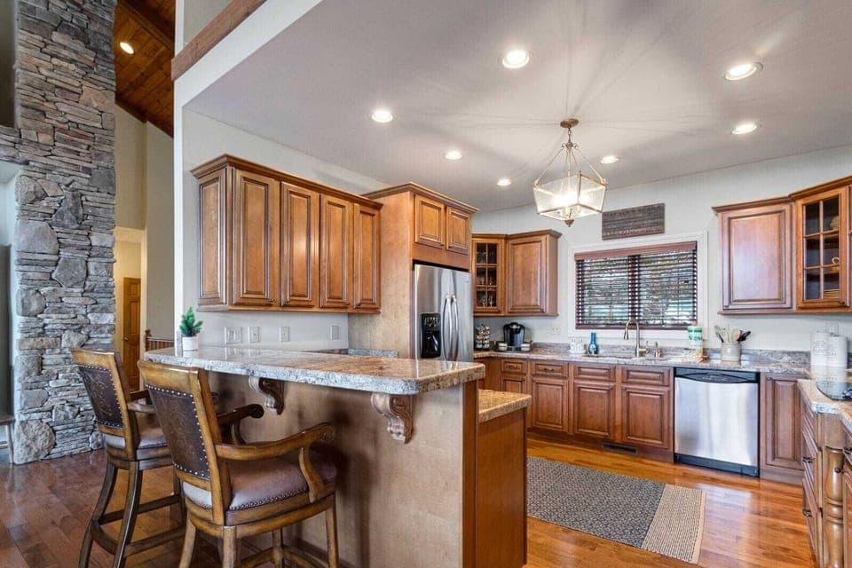 Kitchen with Granite Counters, Stainless Appliances and Bar Seating