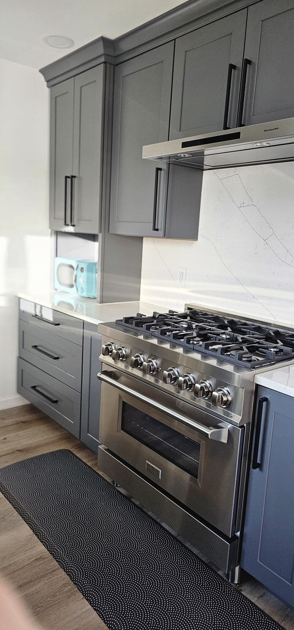 Close Up of 6-burner Gas Stove/Oven & Microwave; Quartz Countertops.