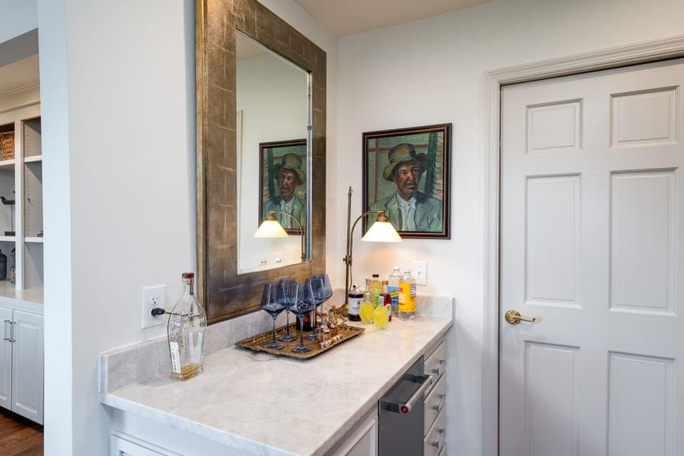 Tucked around the corner from the dining area is the bar. Beverage refrigerator is a bonus