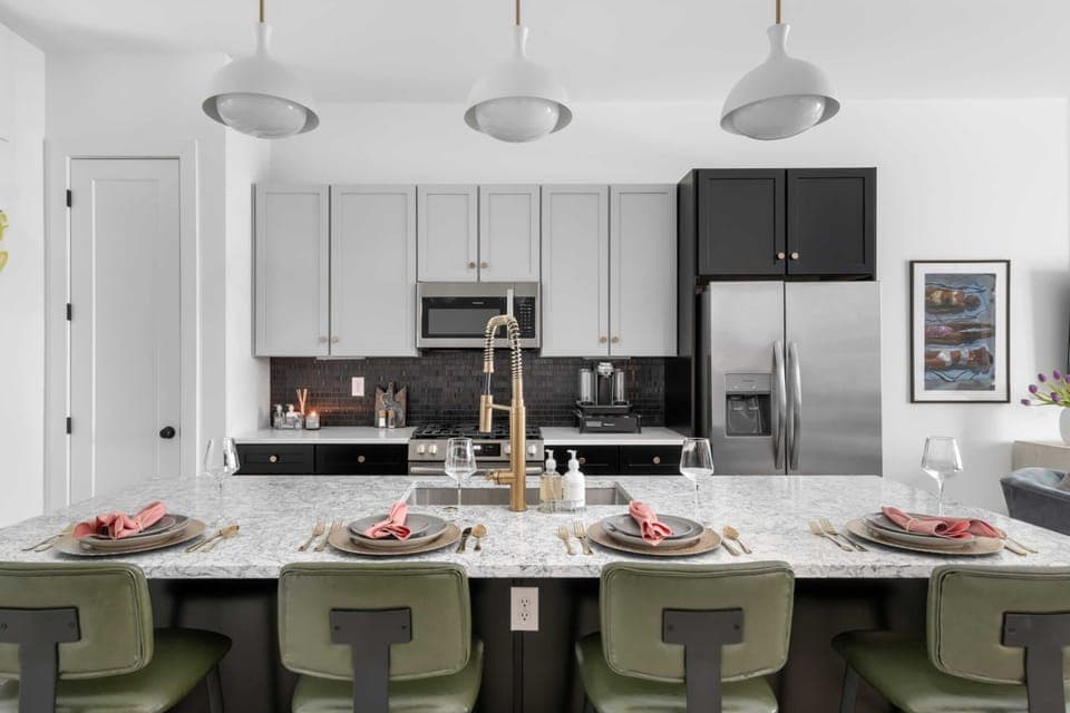 Clean and Spacious Kitchen with Sleek Countertops and Seating
