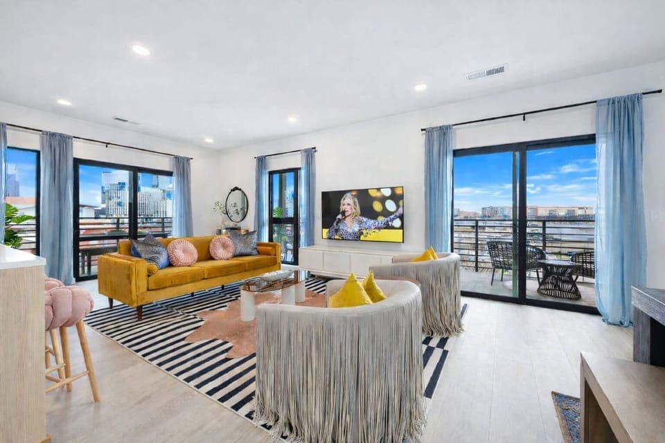 Trendy and spacious living room featuring modern designer furnishings, and a Smart TV for entertainment.