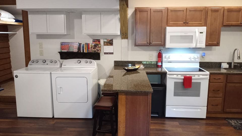 Laundry area.  Games and books for children. small bar area with 2 bar stools.