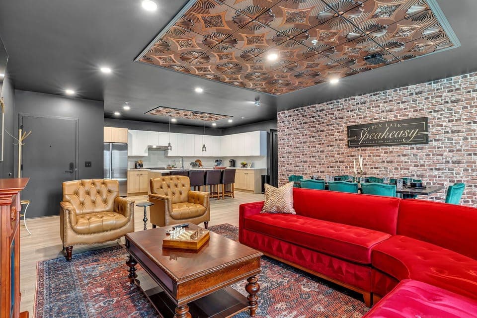 Open-floor living space featuring a smart flat-screen TV and designer furnishings. This inviting area effortlessly connects the dining space with the well-appointed kitchen.