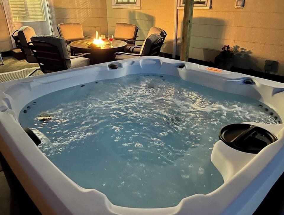 Soak up the Southern sky at the cottage under string lights.  Fire table and cushioned seating to enjoy a glass or wine or coffee in the morning.  Both homes have a hot tub and fire table.