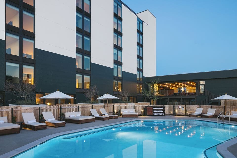 Dive into a sparkling evening swim under soft patio lights.