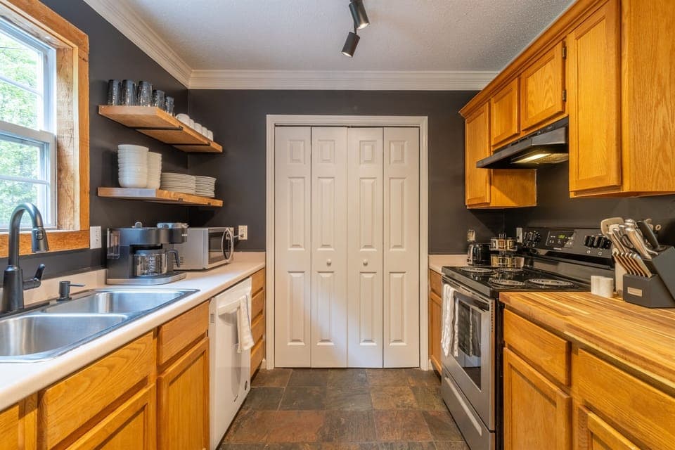 Kitchen view and utility room where you'll find the washer/dryer and additional chairs for dinning