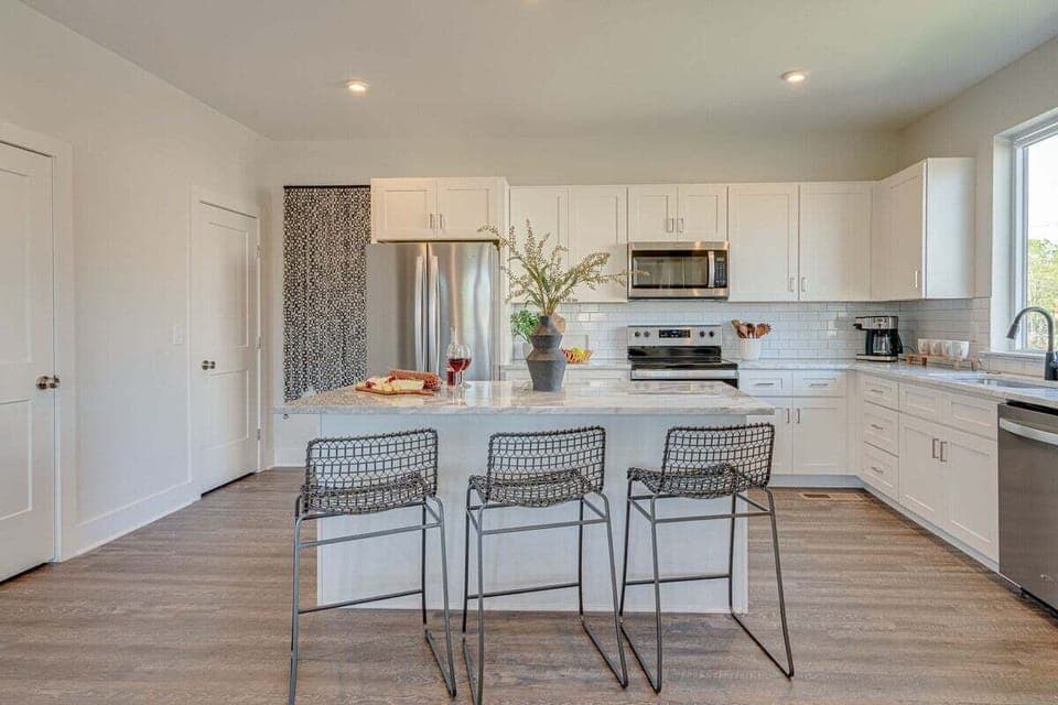Fully equipped kitchen stocked with basic cooking essentials and stainless steel appliances.