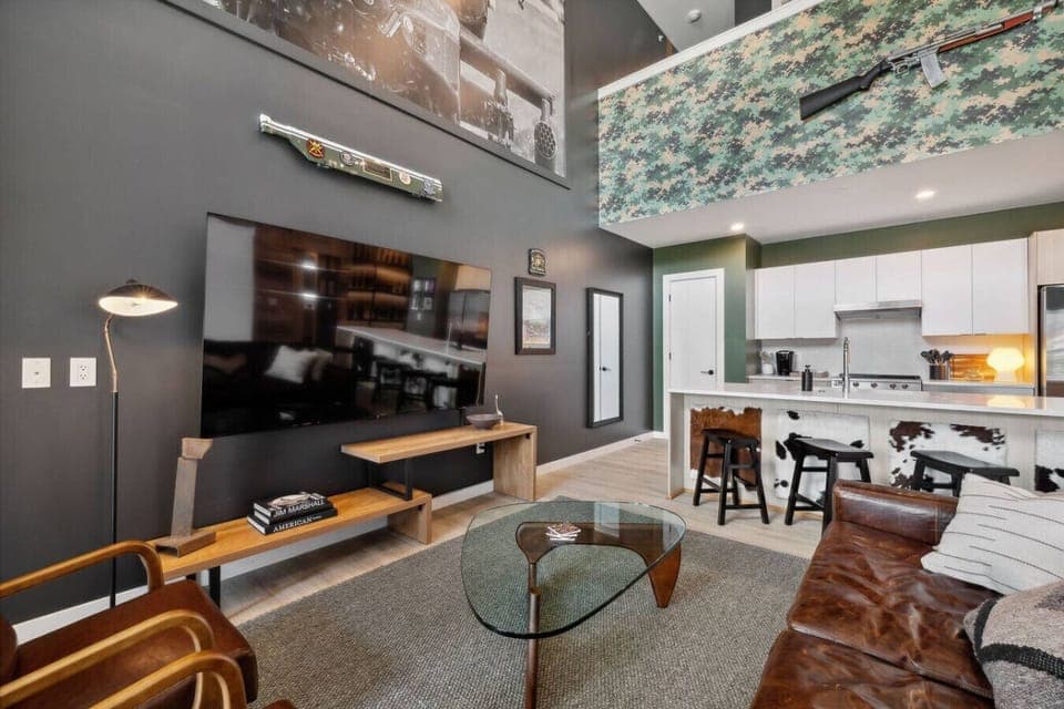 Living room with Smart TV, two queen Murphy beds, and private patio access