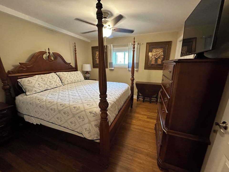 Bedroom 2 has a king bed, dresser, 2 night stands and a smart tv