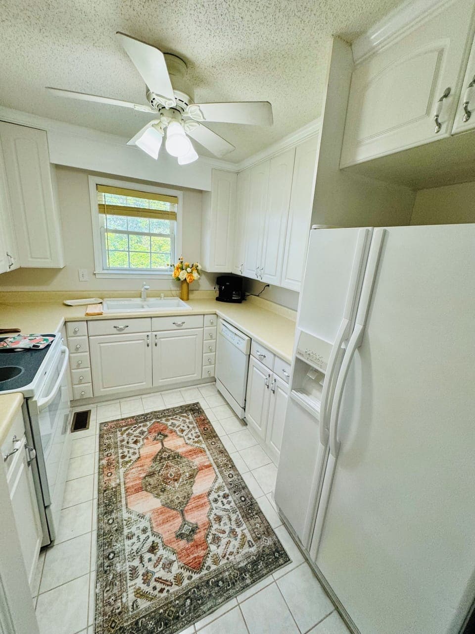 Fully equipped kitchen with generous counter space and a peaceful window view