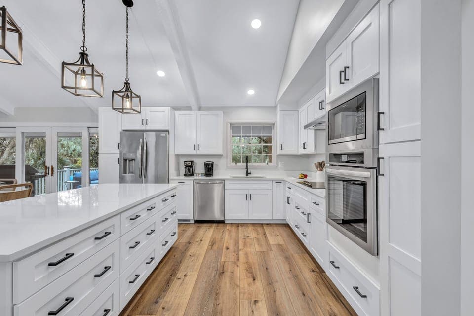 Open-plan layout of the main level living area transforms mealtime into a joyous occasion, offering ample seating at the kitchen island and adjacent dining tables.