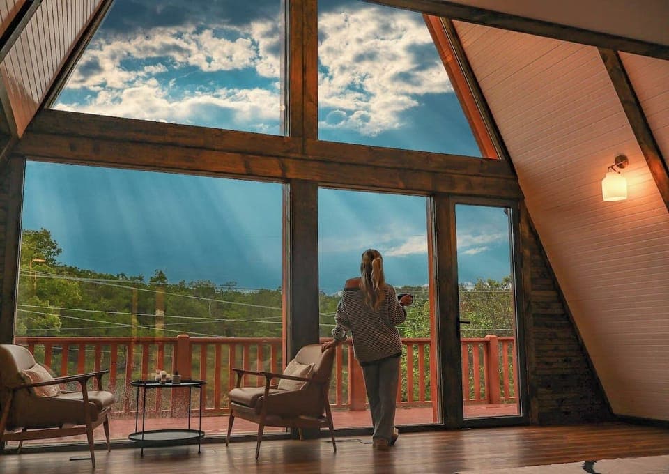 Double A-Frame Living Room: Stunning views await in this airy retreat with stylish seating and natural light!