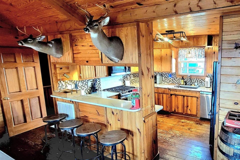 Kitchen bar with 4 swivel stools.  Enjoy an afternoon snack or a beverage!