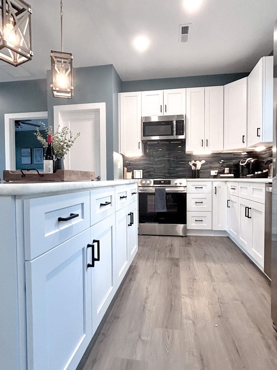 Full kitchen with modern amenities and island with seating. (3)