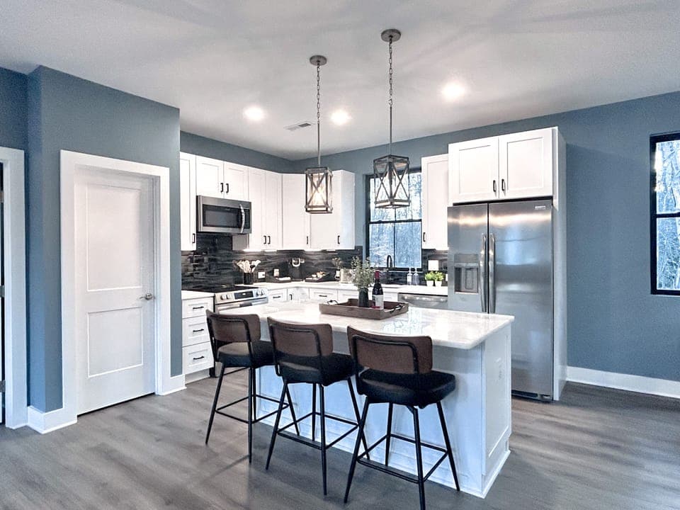 Full kitchen with modern amenities and island with seating. (2)