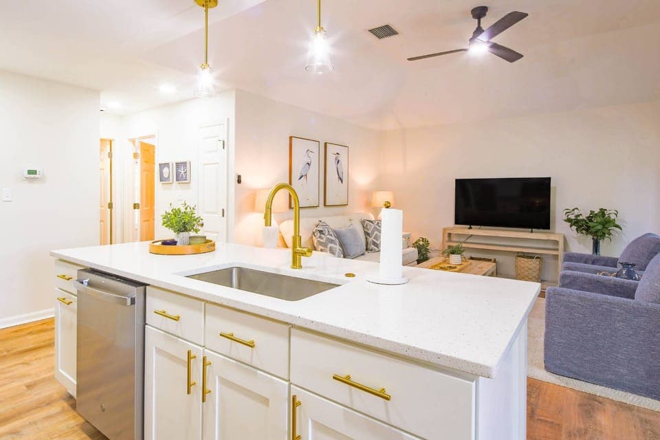 The kitchen's central island looks out onto the villa's comfortable living room.