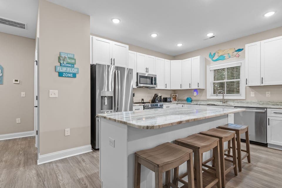 Your spacious kitchen features granite countertops, stainless steel appliances, and a breakfast bar perfect for morning coffee or casual dining together.