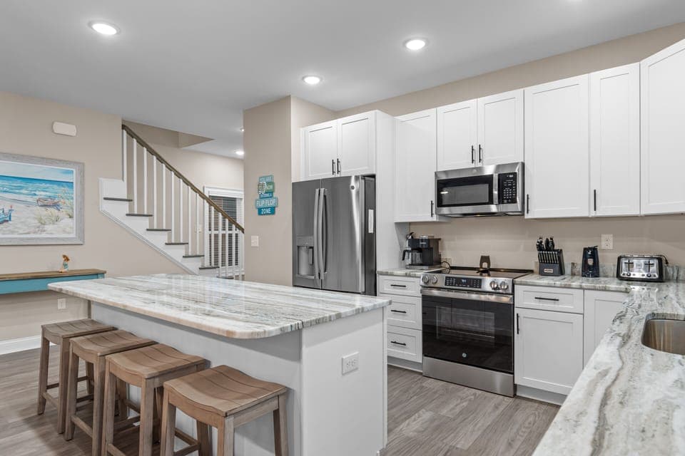 Your fully equipped kitchen features granite countertops and stainless steel appliances, perfect for preparing meals during your stay.