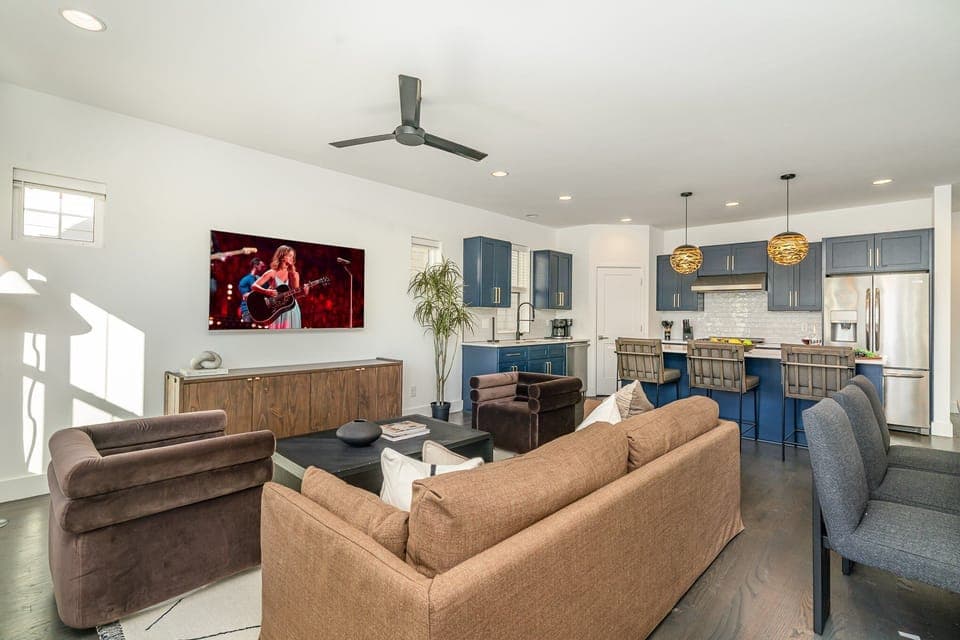Relax in the cozy and stylish living room, complete with comfortable seating, a flat-screen TV, and large windows that bring in plenty of natural light.