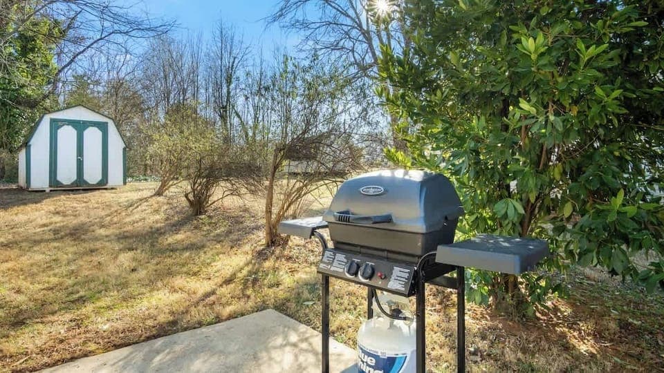 Outdoor grill ready for your BBQ gatherings, surrounded by a peaceful backyard setting.