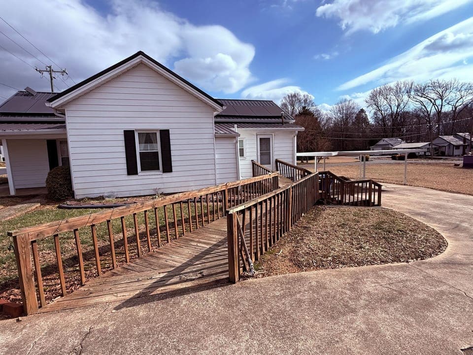 Main side entrace. Decked ramp and stairs.
